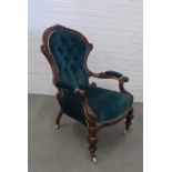 Victorian mahogany framed open armchair, button back green upholstery on ceramic castors. 102 x 71 x
