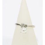 Pearl and diamond ring, the large cultured pearl offset by two brilliant cut diamonds, on a plain