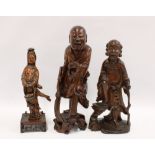 Two fruitwood immortal figures, together with another wooden figure of Guanyin, tallest 34cm (3)