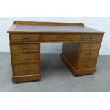 Late 19th century mahogany pedestal desk with red leather skiver and an arrangement of nine drawers,