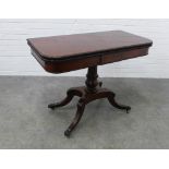 Regency style foldover mahogany tea table with a rectangular hinged top with a beaded rim over a