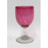 Large cranberry glass goblet on clear glass stem and foot, 21cm.