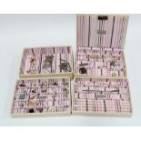 A 'Stackers' cream leather jewellery box, four trays containing a collection of costume jewellery to
