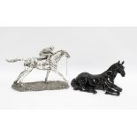 Black gloss model of a horse together with another of a jockey and racehorse, 32cm long, (2)