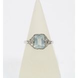18ct white gold aquamarine and diamond dress ring with an emerald cut aquamarine with three