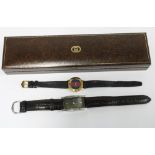 Ladies Gucci 3000 wrist watch with striped dial on a black leather strap together with another gucci
