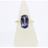 18ct gold Iolite dress ring, claw set with a single stone with facet cuts, hinged band stamped