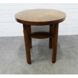 An Art Deco two tier table with circular veneered top and stylised legs, . 61 x 60cm.