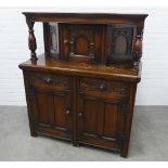 Reproduction court cupboard of typical design with carved and panelled doors and drawers. 140 x