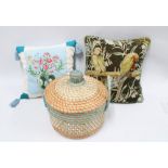 Two contemporary scatter cushions and a basket (3)