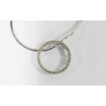 Diamond pendant of circular outline claw-set with round brilliant-cut diamonds, stamped 18k 750,