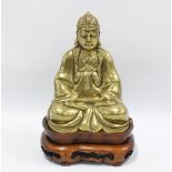 Tibetan style gilt bronze Buddha, signed, on two part wooden stand, 25cm including stand