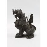 A chinoiserie carved wood temple lion, 14cm.