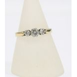 18ct gold and platinum diamond ring, claw set with three brilliant cut diamonds, inner band dated '