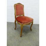 Giltwood side chair with foliate carved frame and pale red velvet upholstered back and seat, on