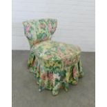 Late 19th / early 20th century bedroom chair with floral patterned cover, raised on mahogany legs