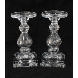 A pair of clear glass candlesticks, knop stemmed with square bases, (2) (one a/f) 24cm.