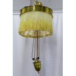 An early 20th Century Arts and Crafts hanging ceiling pendant light with a circular brass surround