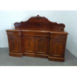 19th century mahogany inverted sideboard with a carved foliate scroll back above frieze drawers,
