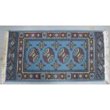 Small Afghan bokhara rug with pale blue field, 135 x 69cm