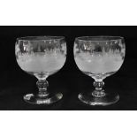 A pair of clear glass comport vases, wheel engraved with hunting scene, (2) 18cm.
