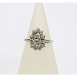 Diamond cluster ring, claw set with two graduating central diamonds within a surround of eleven