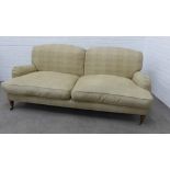 Contemporary two seater settee of traditional design, upholstered in beige with a gold sheen, on