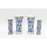 A pair of delft blue and white vases with frilled rims and floral pattern together with a pair of