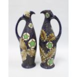 A pair of continental pottery jug vases of elongated form, each with a textured blue ground with