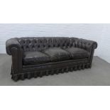 Chesterfield sofa, typical design with pleated skirt, 60 x 206 x 59cm.