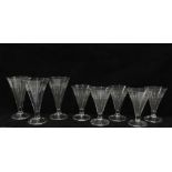 Set of eight drinking glasses, conical bowls with engraved border pattern and a teardrop bubble