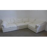 Large sectional corner sofa group, in four parts, with cream covers and squab cushions, all