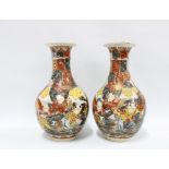 A pair of Japanese earthenware vases, typically decorated with figures and stylised motifs (2) 30.