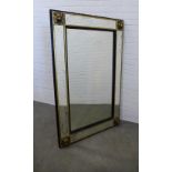 Large wall mirror, the rectangular plate within an ebonised and parcel gilt frame with lion mask