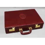 Must de Cartier burgundy leather briefcase with monogrammed interior, locking mechanism and outer