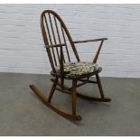 Ercol dark elm rocking chair with loose floral cushion