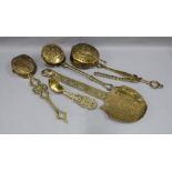 A collection of brass chestnut roasting pans and loving spoons, (a lot)