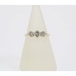Early 20th century diamond three stone ring, claw set in platinum on a an unmarked gold band , circa