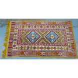 20th century Moroccan rug, orange field with two medallions within multiple flowerhead borders, with