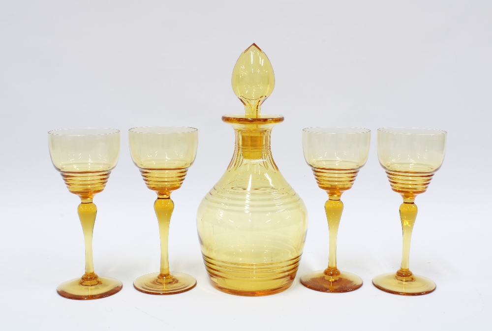 Early 20th century amber glass decanter with stopper and set of four glasses (5) 17cm.