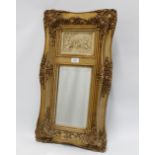 Moulded gilt framed mirror, the rectangular plate surmounted by a faux stoneware plaque with