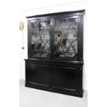 19th century black lacquered bookcase cabinet, cornice top above a pair of astragal glazed doors