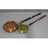 Copper bed warming pan and a brass bed warming pan, both with turned wooden handles (2)