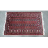 Bokhara rug with red field and two rows of thirteen guls within a multiple border, 152 x 97cm