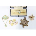 A collection of gold and yellow metal brooches to include an 18ct brooch with pearl and two rubies ,