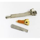 Silver cigar cutter, London 1972, 15cm long, a gold plated cigar cutter with leather panels and a