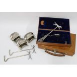 Two leather boxes containing riding boot pulls to include steel and bone handled examples, (a lot)