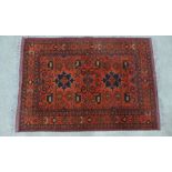 Persian rug with red field and central hooked medallion with serrated leaf motifs, multiple borders,