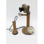 An early 20th century vintage brass / copper and Bakelite candlestick telephone, with chromed