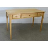 Modern beechwood desk/table the rectangular top above two frieze drawers and one fall front
